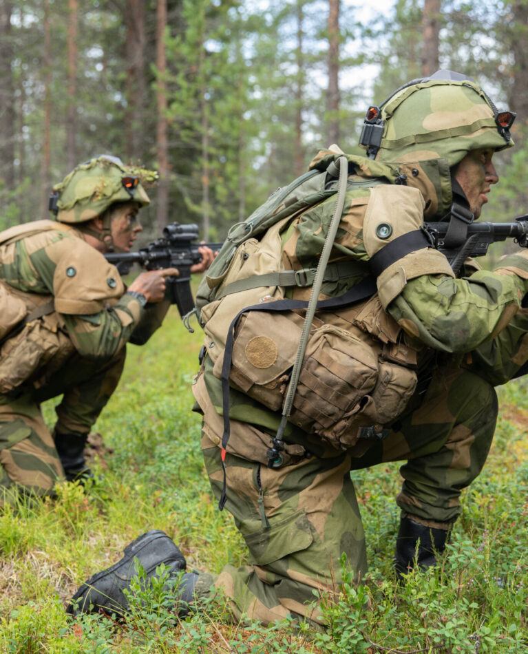 Two Norwegian soldiers, assigned to 2nd Armored Squadron, 1st Armored Battalion, conduct a simulated offensive attack on U.S. Soldiers, assigned to “Viper” Company, 1st Battalion, 26th Infantry Regiment, 2nd Brigade Combat Team, 101st Airborne Division (Air Assault), role-playing as oppositional forces, during Exercise Ryske 2022 at Rovajärvi Training Area, Finland, July 28, 2022. Exercise Ryske is a combined, joint training exercise conducted by the United States, Finland, and Norway to strengthen relations and help build interoperability between partner nations. The 101st Airborne Division (Air Assault) is under command and control of V Corps—America's forward-deployed corps in Europe, working alongside allies and regional security partners to provide combat-credible forces. (U.S. Army photo by Spc. Austin Steinborn)