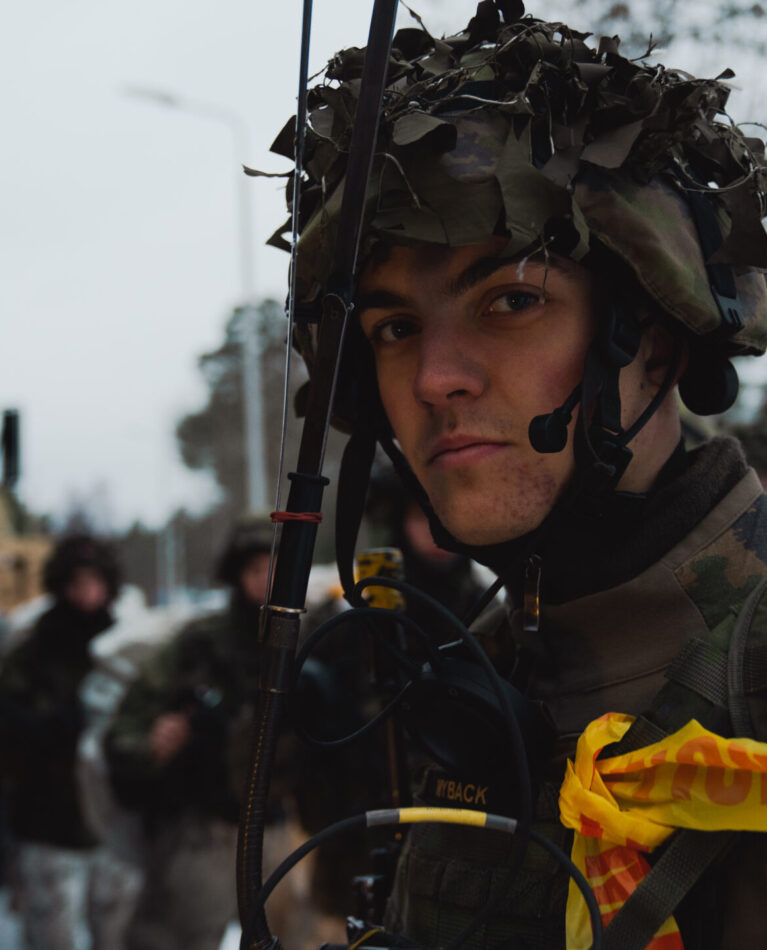A Finnish soldier with the Nylands Brigade waits to board a U.S. Marine Corps medium tactical vehicle replacement cargo truck during exercise Freezing Winds 22 in Dragsvik, Finland, Nov. 26, 2022. Task Force Red Cloud, headquartered by elements of Combat Logistics Battalion 6 (CLB-6), is deployed to Finland in support of Exercises SYD 2022 and Freezing Winds 2022 to enhance U.S. and Finnish select interdependence in the maritime domain; solidify bilateral maritime maneuver within the Finnish littoral environment; and foster strong relationships between U.S. Marine Corps and Finnish Defense Force sustainment units. (U.S. Marine Corps Photo by Lance Cpl. Maxwell Cook)
