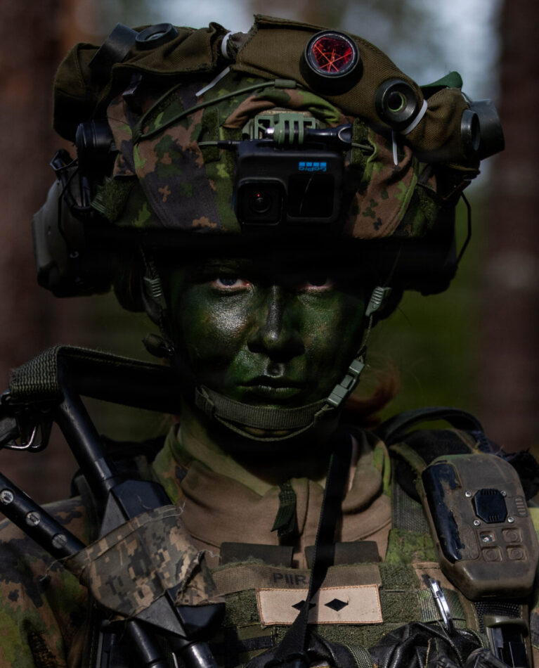 Salla Piira, a Finnish combat camera and conscript with Kainuu Brigade, poses in a woodline with her standard equipment during a Saber Strike force-on-force event at Vuosanka Training Area, May 19, 2026. From April 27 to May 31, 2026, U.S. and Allied forces will exercise NATO’s Eastern Flank Deterrence Initiative, demonstrating NATO’s ability to fight and win on the modern battlefield. Nearly 15,000 troops from eleven nations will train across the High North, Baltic region, and Poland, executing rapid maneuvers, air defense, counter-drone operations, and cyber defense to validate NATO’s regional defense plans in real time. This series of linked exercises, including Saber Strike, Immediate Response, and Swift Response, turns investment into capability. Soldiers integrate unmanned systems, AI-enabled command and control, and live data networks to move faster, decide faster, and fight more effectively across all domains. Sword 26 demonstrates how U.S. Army Europe and Africa drives transformation at scale while strengthening deterrence. Together with our Allies, we are building a unified, lethal force ready to defend NATO territory and respond to any threat. (U.S. Army Reserve photo by Addison Shinn)