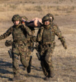 Swiss Armed Forces carry a litter on Feb. 17, 2025 as a part of the U.S. Army Europe and Africa International Tank Challenge at 7th Army Training Command’s Grafenwoehr Training Area, Germany. The USAREUR-AF International Tank Challenge builds tactical skills and enhances esprit de corps across the 11 crews from five participating Allied and Partner for Peace nations. (U.S. Army photo by Pfc. Brent Lee)