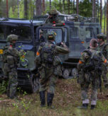 A group of Finnish soldiers talk amongst one another near a Finnish Sisu NA-110 tracked vehicle on May 27, 2026 at Vuosanka Training Area, Finland. From April 27 to May 31, 2026 U.S. and Allied forces will exercise NATO’s Eastern Flank Deterrence Initiative, demonstrating NATO’s ability to fight and win on the modern battlefield. Nearly 15,000 troops from eleven nations will train across the High North, Baltic region, and Poland, executing rapid maneuvers, air defense, counter-drone operations, and cyber defense to validate NATO’s regional defense plans in real time. This series of linked exercises, including Saber Strike, Immediate Response, and Swift Response, turns investment into capability. Soldiers integrate unmanned systems, AI-enabled command and control, and live data networks to move faster, decide faster, and fight more effectively across all domains. Sword 26 demonstrates how U.S. Army Europe and Africa drives transformation at scale while strengthening deterrence. Together with our Allies, we are building a unified, lethal force ready to defend NATO territory and respond to any threat. (U.S. Army Reserve photo by 1st Sgt. Austin Berner)