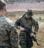 U.S. Marine Corps Sgt. Chorin Weller, left, an assistant transmissions chief with 2nd Force Reconnaissance Company, 2nd Reconnaissance Battalion, 2nd Marine Division, observes a Finnish Navy sailor with Coastal Brigade, Naval Reconnaissance Battalion, Naval Reconnaissance Company, demonstrate how to operate an RK 62M assault rifle during Finnish weapons and boat familiarization training as part of exercise Narrow Waters 26 in Upinniemi, Finland, May 15, 2026. The familiarization training increased interoperability between allied forces and improved the Marines understanding of Finnish maritime capabilities and weapons systems. (U.S. Marine Corps photo by Lance Cpl. Hunter J. Kuester)