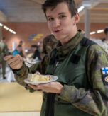 Finnish Jaeger Lucas Jordi Lassenius, a graphics artist for the Conscripts Committee, eats a piece of birthday cake during the U.S. Marine Corps 247th birthday celebration in Dragsvik, Finland, Nov. 10, 2022. U.S. Marines with Combat Logistics Battalion 6 (CLB-6), invited Finnish soldiers to participate in the U.S. Marine Corps 247th birthday celebration and cake cutting ceremony. (U.S. Marine Corps photo by Lance Cpl. Maxwell Cook)